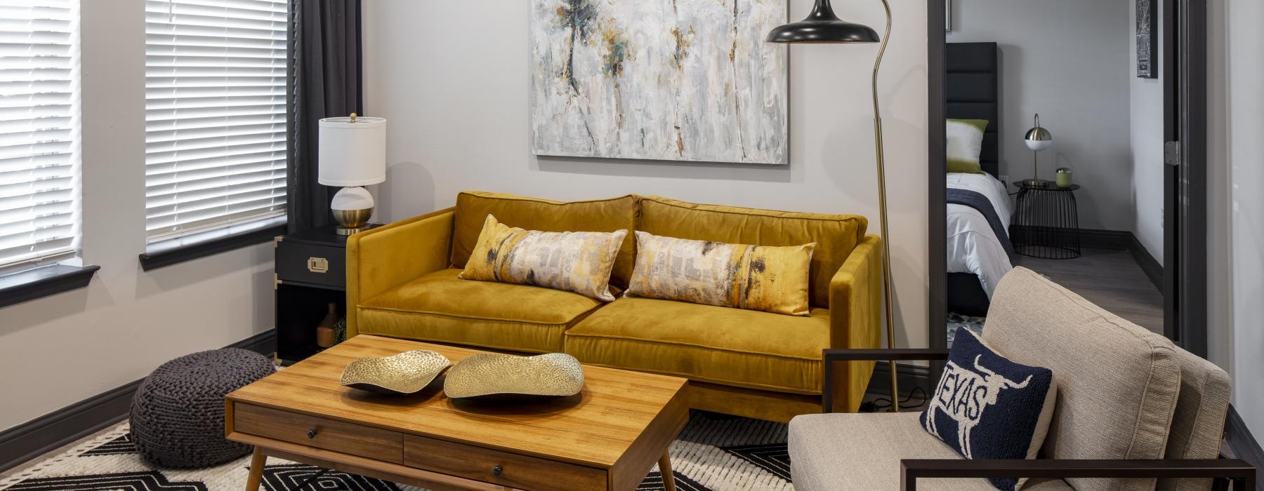 a living room with a yellow couch