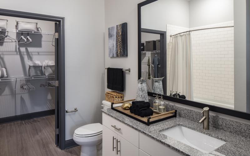 a bathroom with a sink toilet and mirror