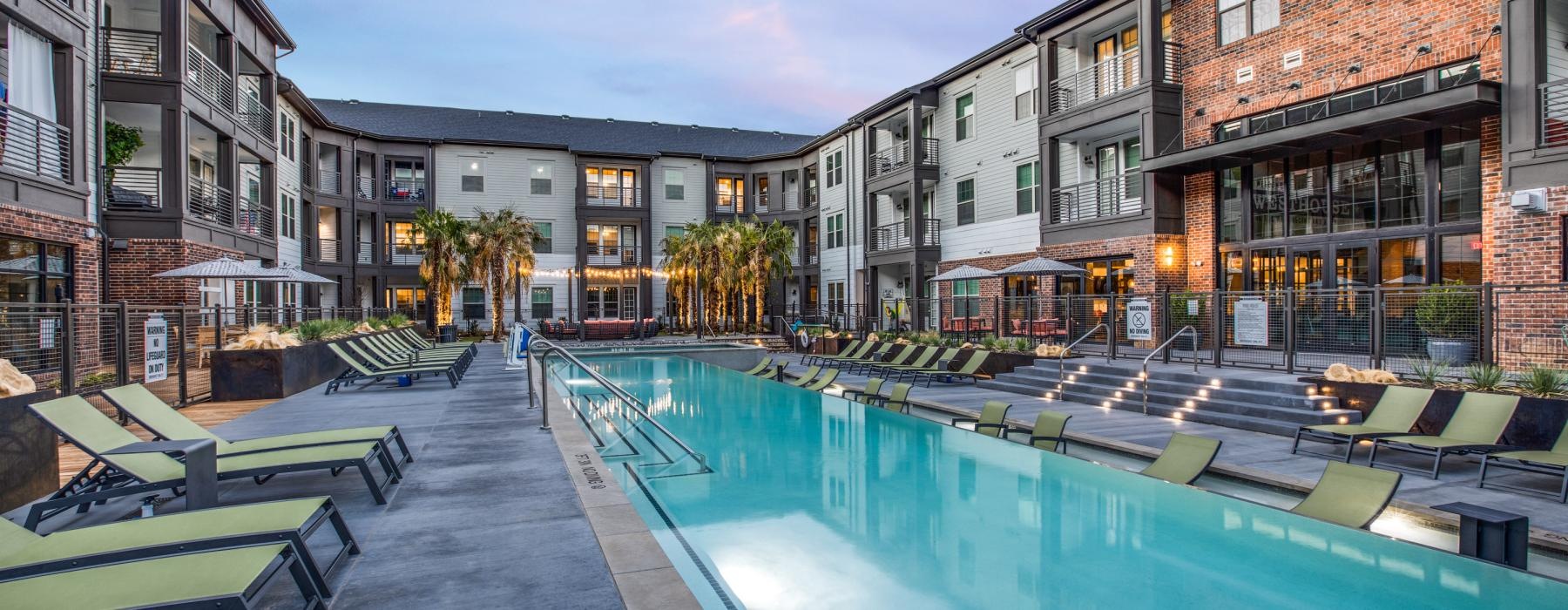 a pool in a courtyard between buildings